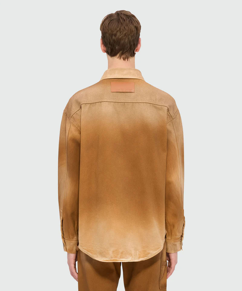 Beige spray-effect denim shirt back view with classic collar and logo label, featuring an oversized fit and rounded hem.