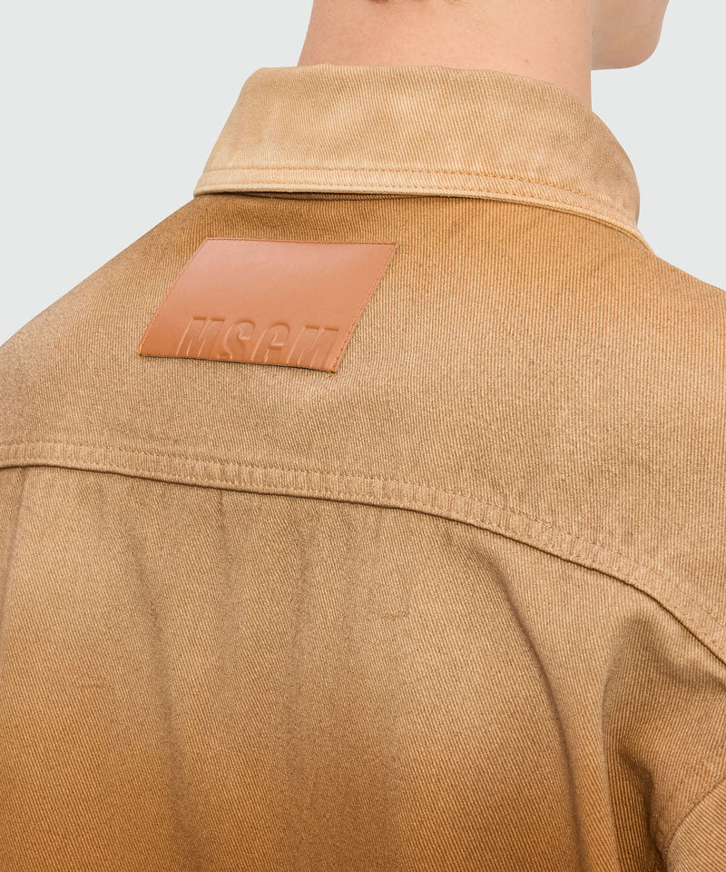 Beige spray-effect denim shirt back view with logo label and classic collar design