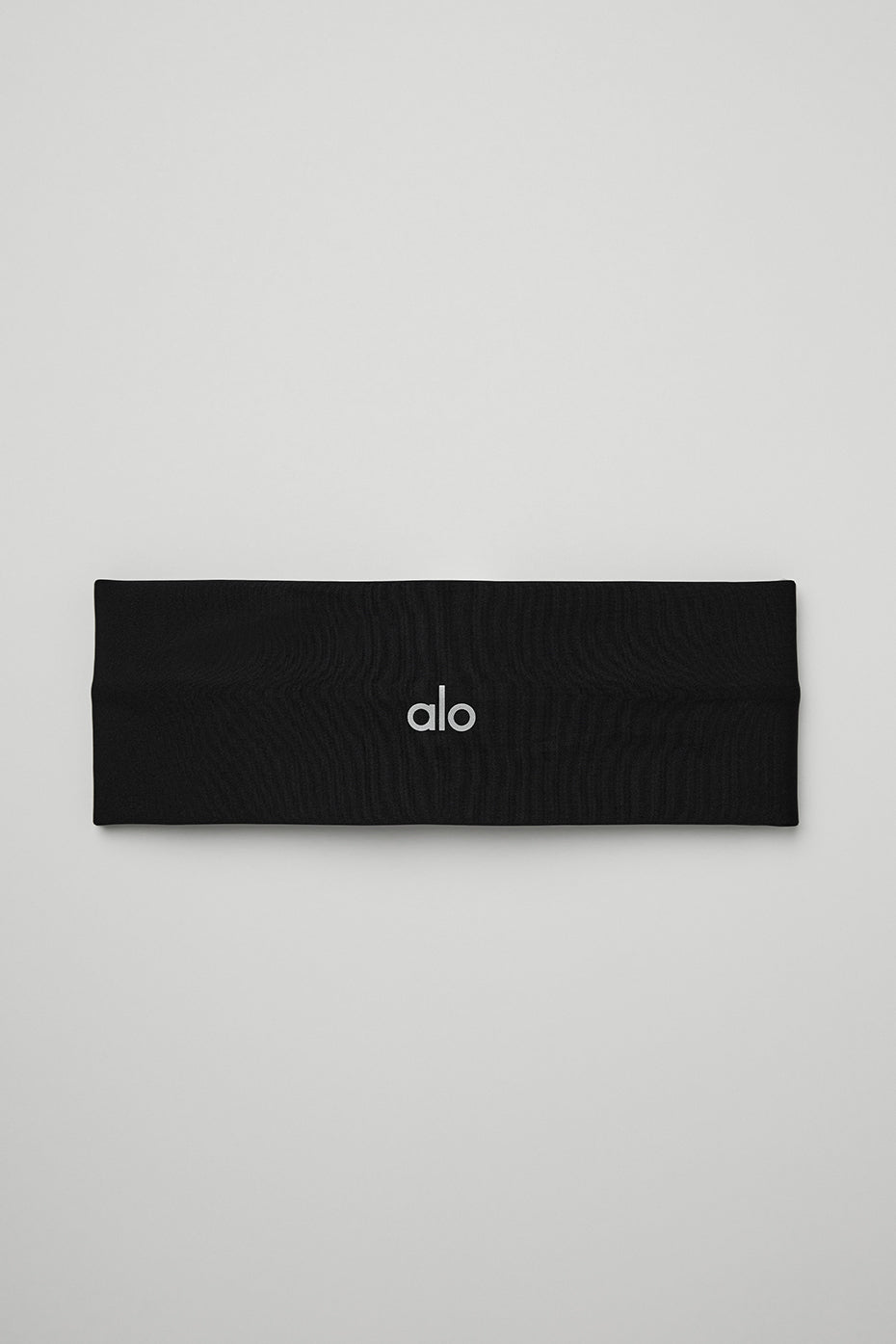 Airlift Headband in black, made from lightweight wicking fabric to manage sweat and keep hair in place during workouts.