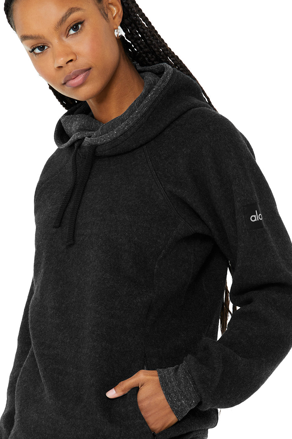 Model wearing The Triumph Hoodie, showcasing its soft triblend fleece and hood design, perfect for yoga or lounging.