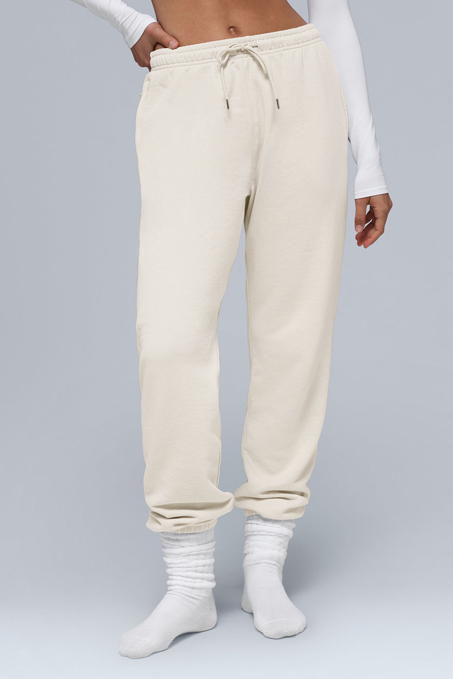 Chill Sweatpant in soft cream color, featuring cuffed bottoms and external drawcords for comfort and style.
