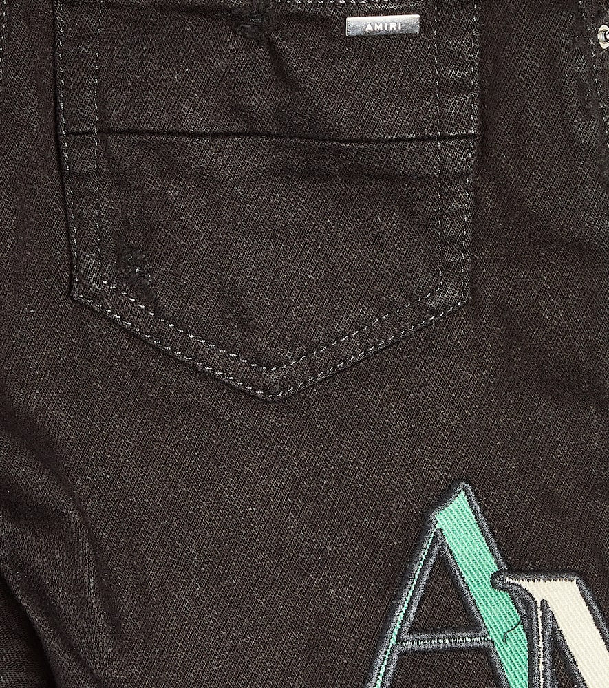 Distressed logo skinny jeans