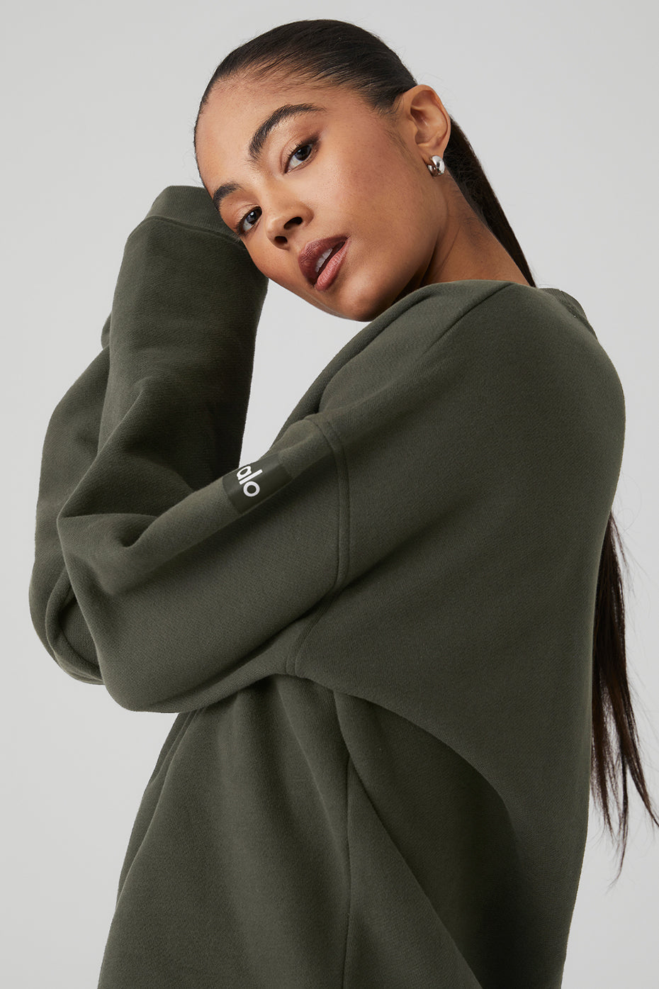 Model wearing Renown Heavy Weight Crew Neck Pullover in olive green, showcasing oversized fit and dropped shoulder design.