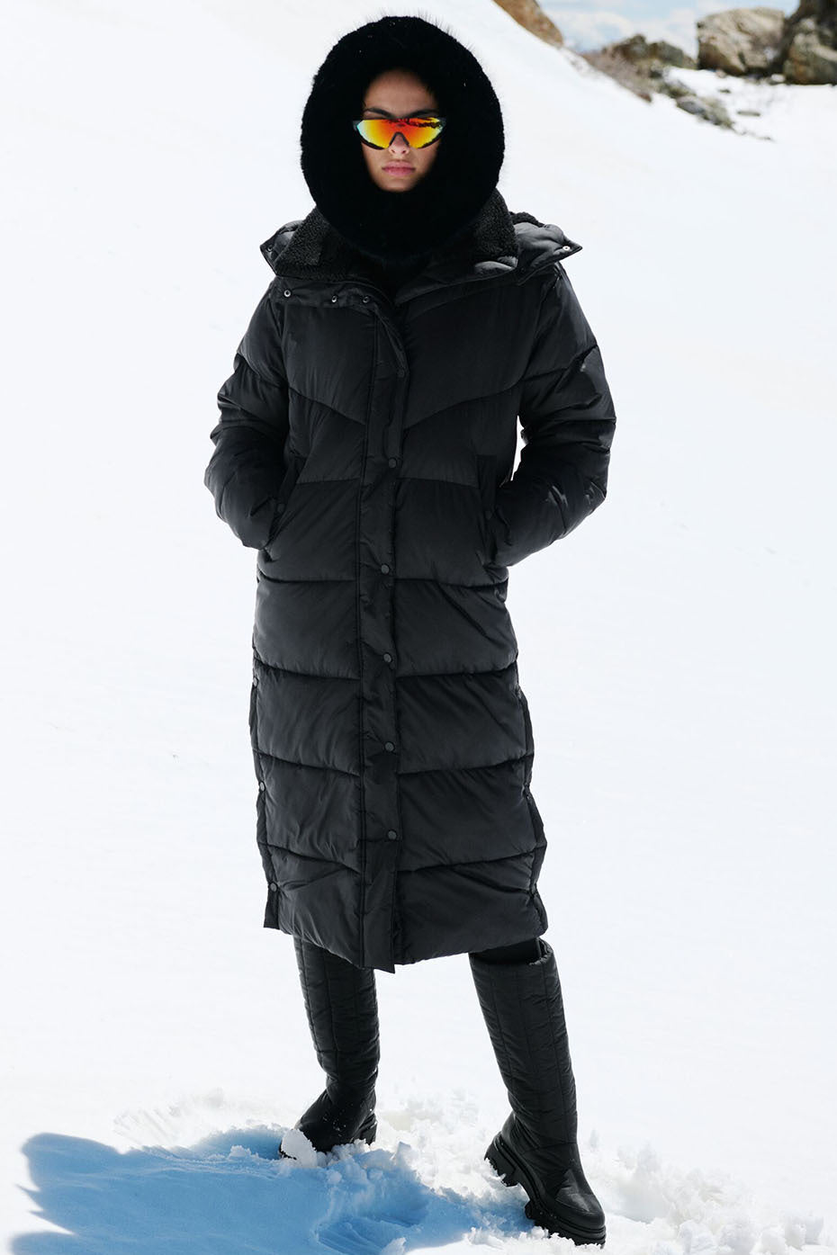 Model wearing Gold Rush Puffer Trench in black, featuring an oversized fit and sherpa-lined collar, perfect for winter.