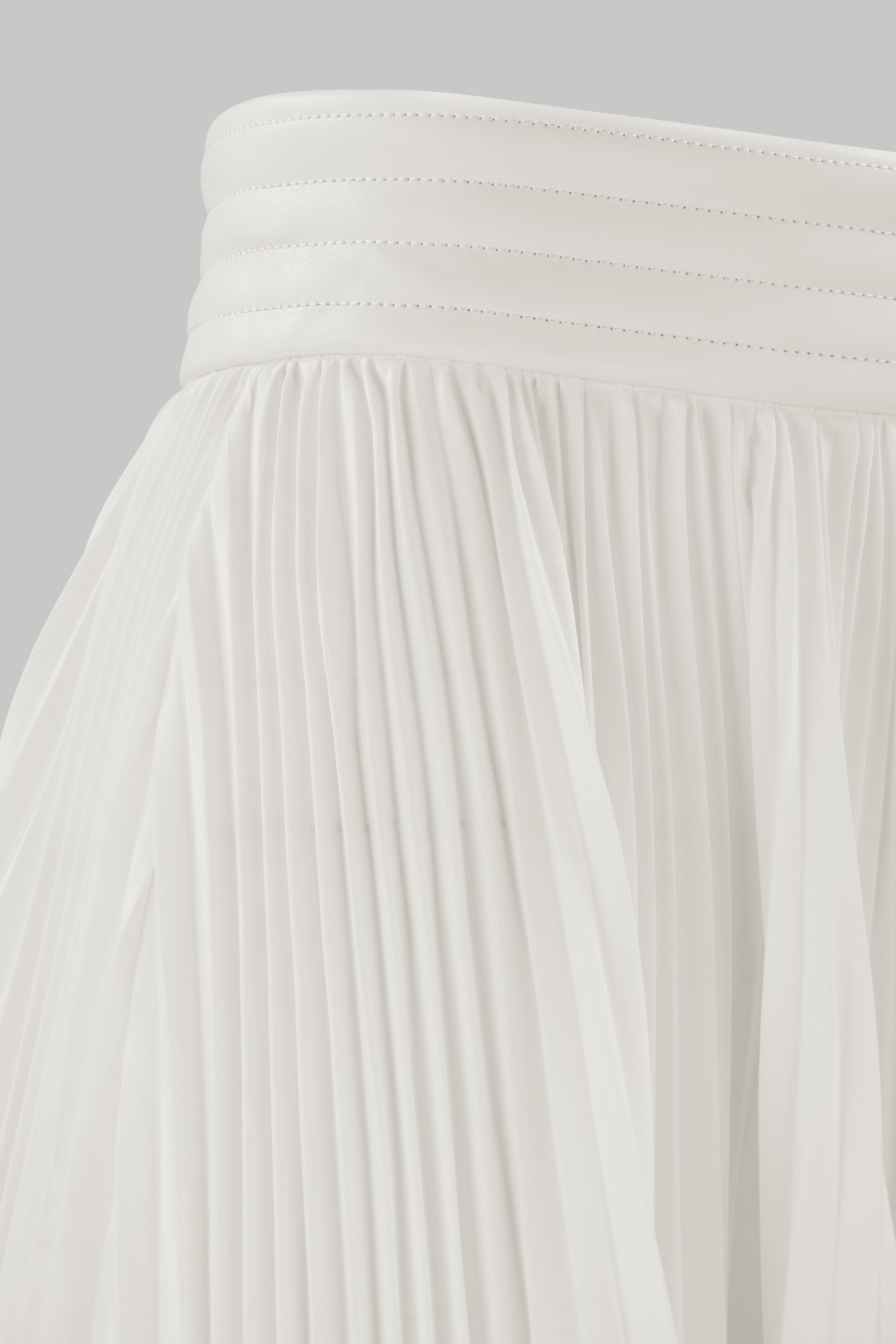 ASYMMETRIC PLEATED SKIRT W/ VEGAN LEATHER WAIST