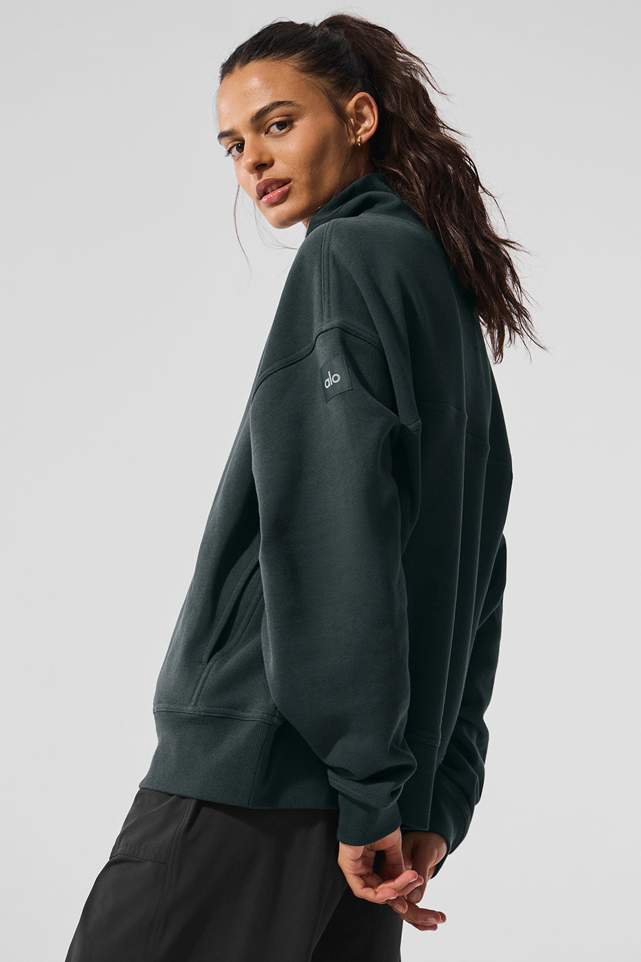 Hazy mock neck pullover in dark green, showcasing its oversized fit and cozy design for stylish comfort.