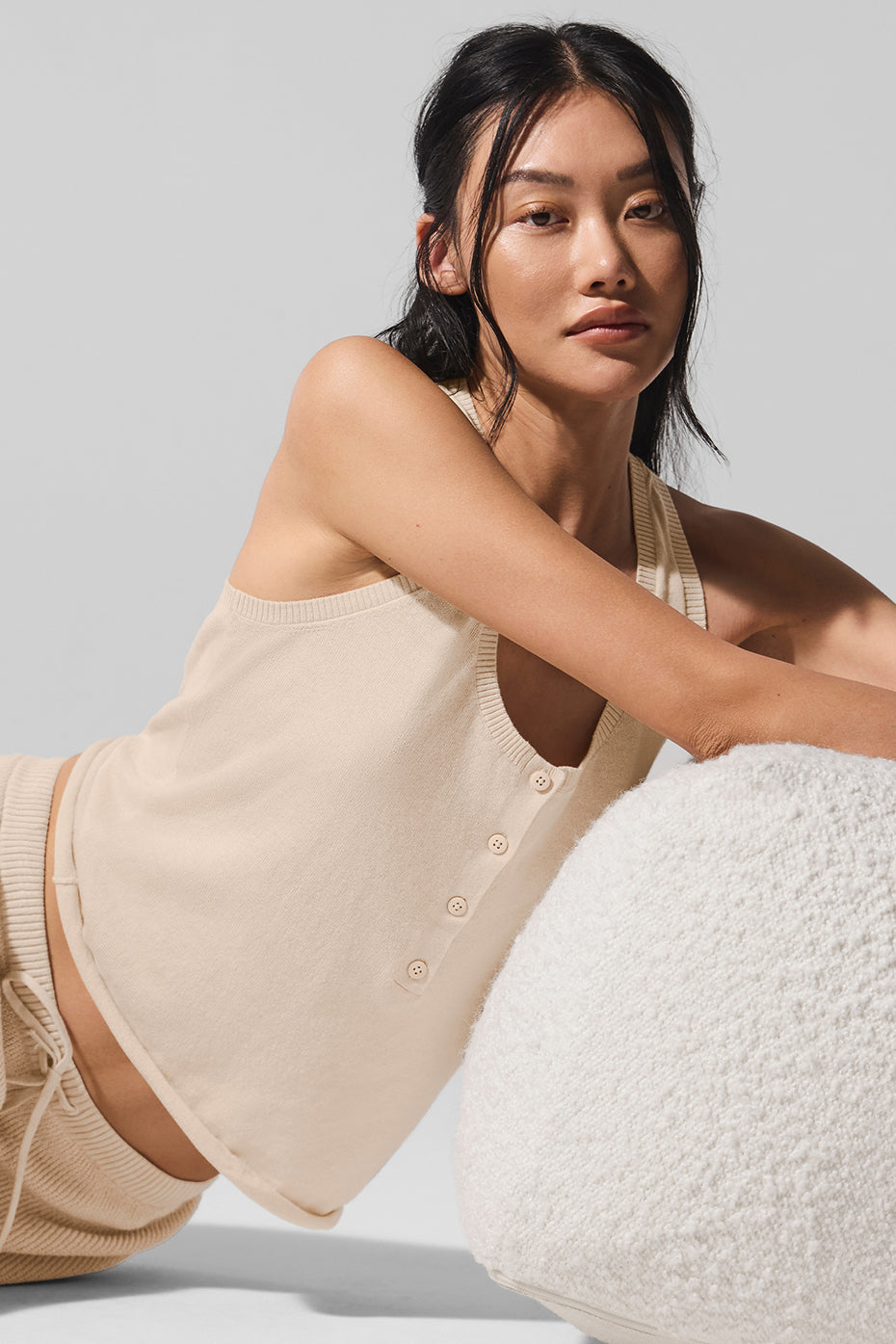 Model wearing Supernatural Sweater Henley Tank in beige, showcasing lightweight knit and relaxed fit style.