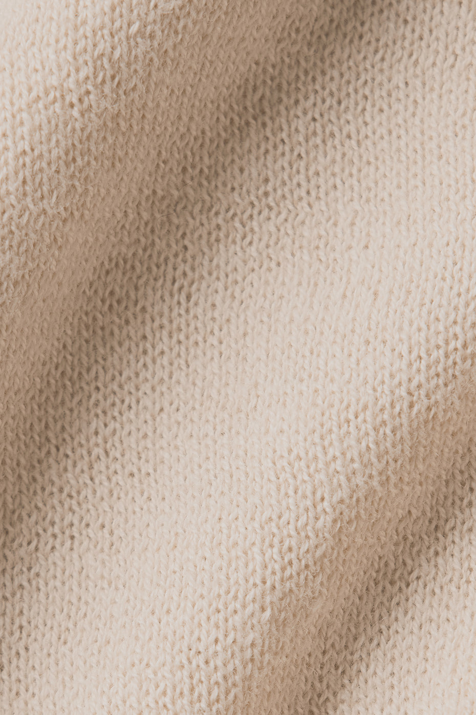 Close-up of lightweight knit fabric in beige, showcasing soft texture ideal for the Supernatural Sweater Henley Tank.