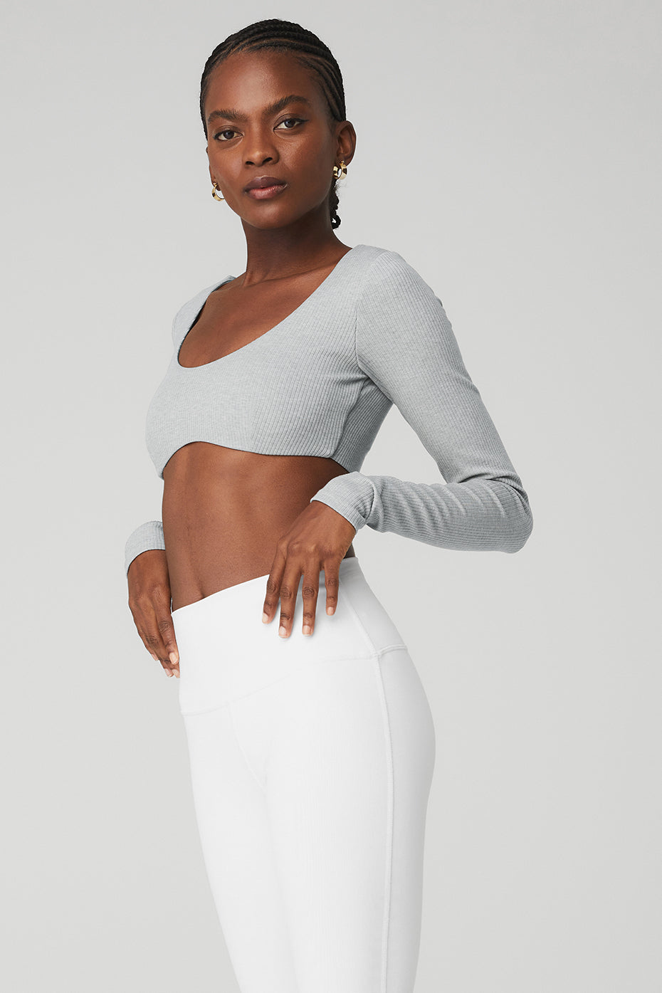 Model wearing gray Ribbed Defined Long Sleeve Bra with removable cups, showcasing a cropped fit and scoop neck design.
