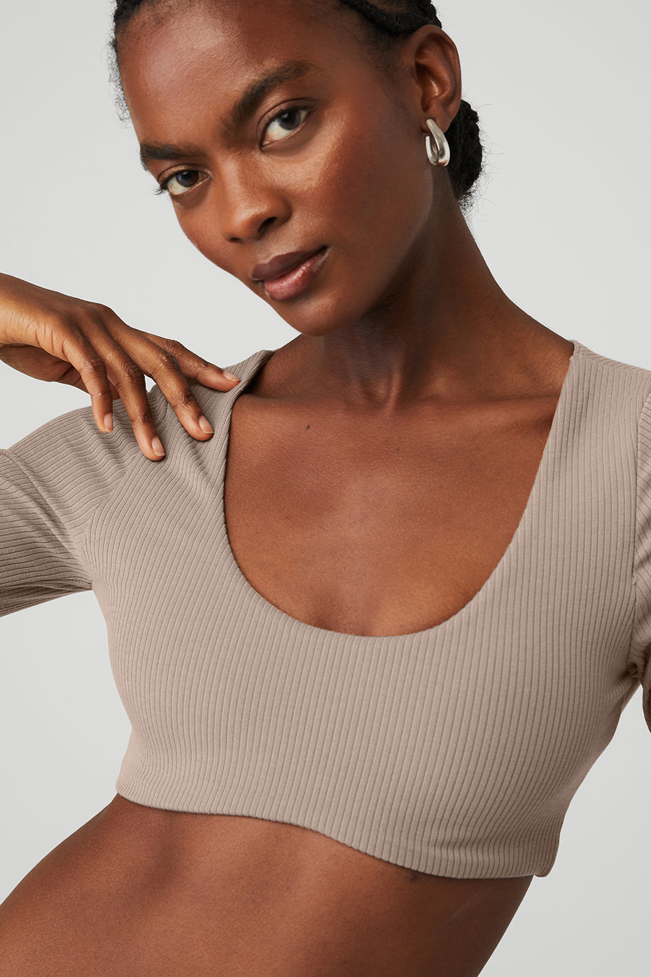 Model showcasing a ribbed defined long sleeve bra with scoop neck and soft fabric, perfect for comfortable styling.