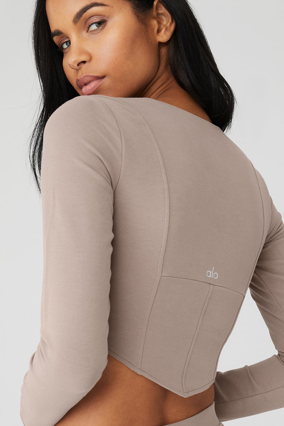 ALO Softsculpt Long Sleeve crop top featuring structured corset panels and soft micro French terry fabric.
