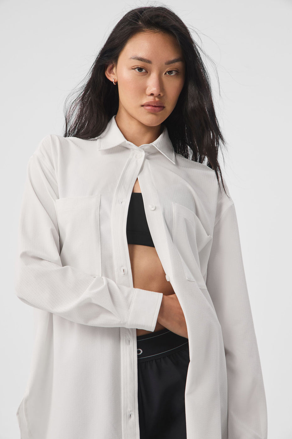 Dreamscape Button Down Long Sleeve shirt in white, featuring a lightweight feel and front pockets, styled casually.