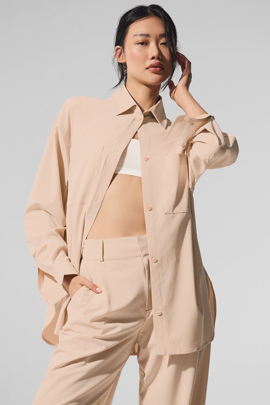 Model wearing Dreamscape Button Down Long Sleeve shirt with front pockets in a lightweight, oversized design.