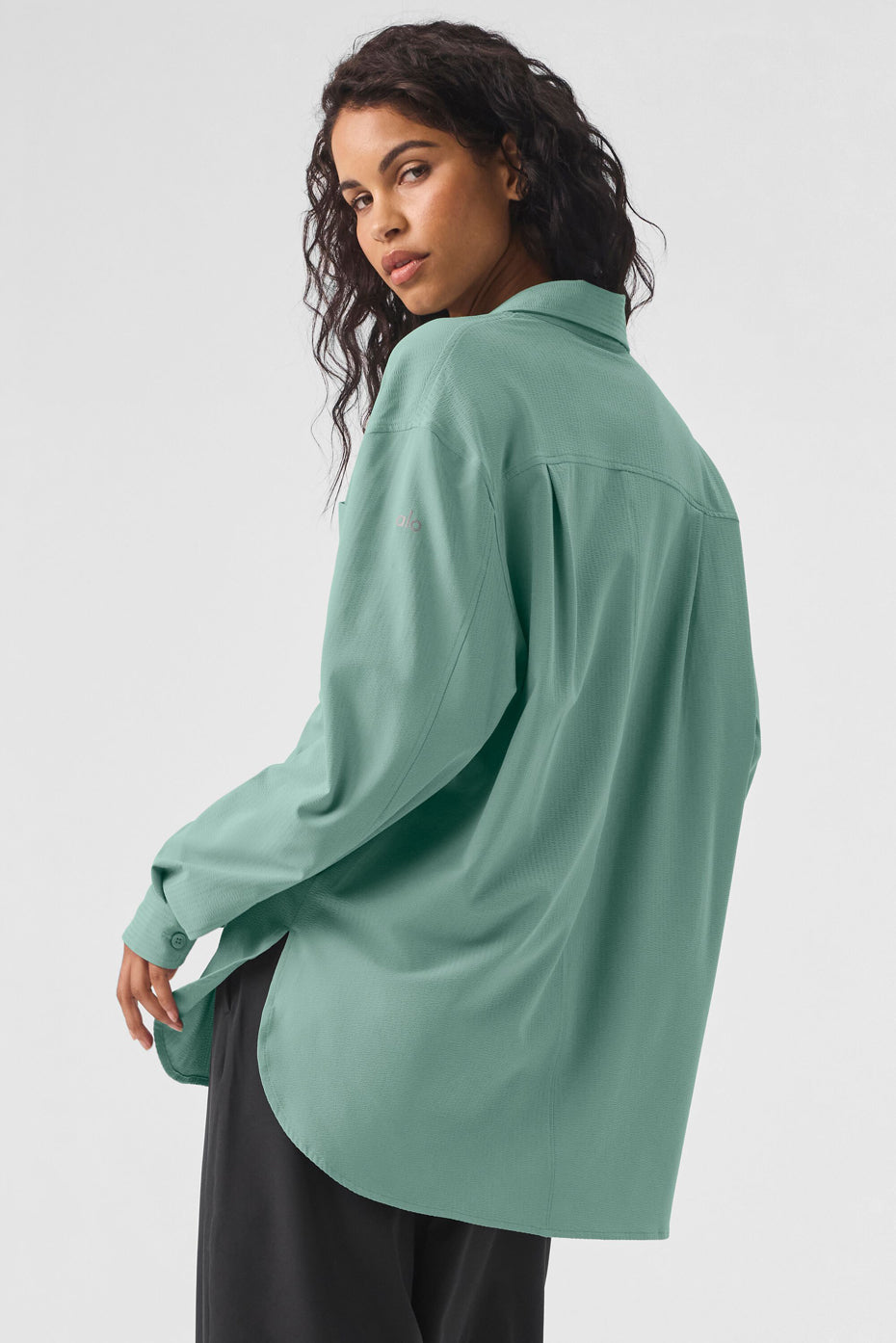 Model wearing the Dreamscape Button Down Long Sleeve in mint green, featuring a relaxed fit and breathable fabric.