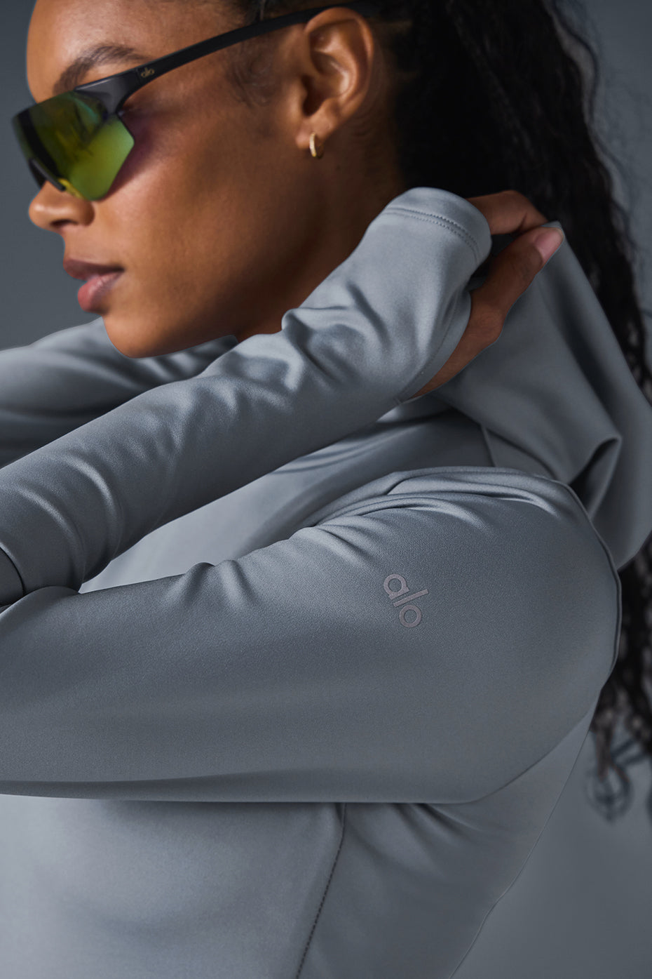 Model wearing Airlift Winter Warm Hooded Runner in gray, showcasing the sleek design and performance fabric.