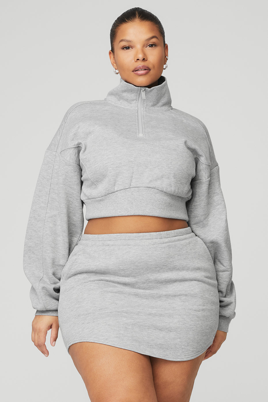 Model wearing Vixen Fleece 1/4 zip pullover with matching skirt in soft grey fleece, showcasing a stylish cropped fit.