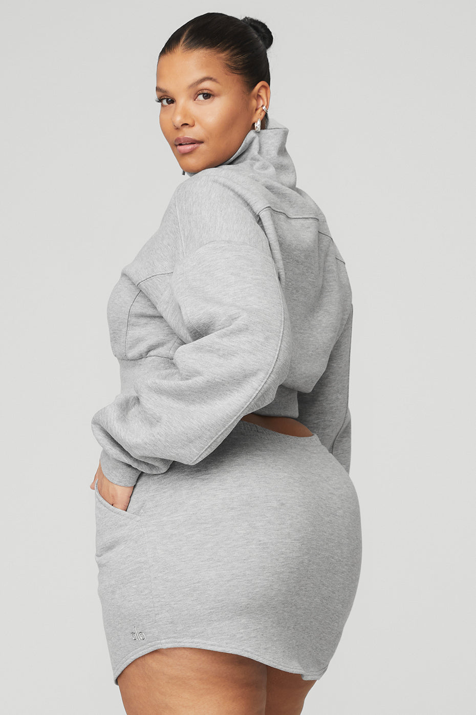 Model wearing gray Vixen Fleece 1/4 Zip pullover with high neck and cropped fit, showcasing a stylish and comfortable outfit.