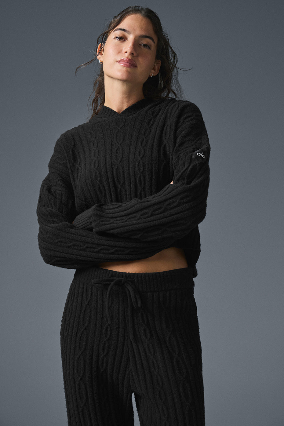 Model wearing Cable Knit Winter Bliss Hoodie with matching pants, showcasing relaxed fit and cozy cable-knit design.