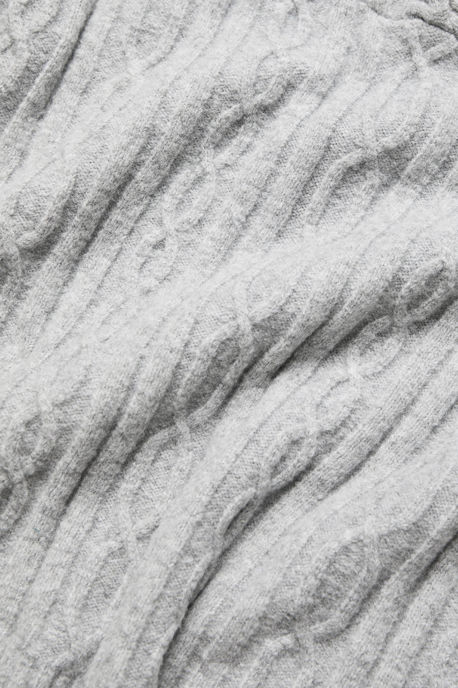 Close-up of the soft gray cable knit texture of the Winter Bliss Hoodie, showcasing its cozy design and relaxed fit.