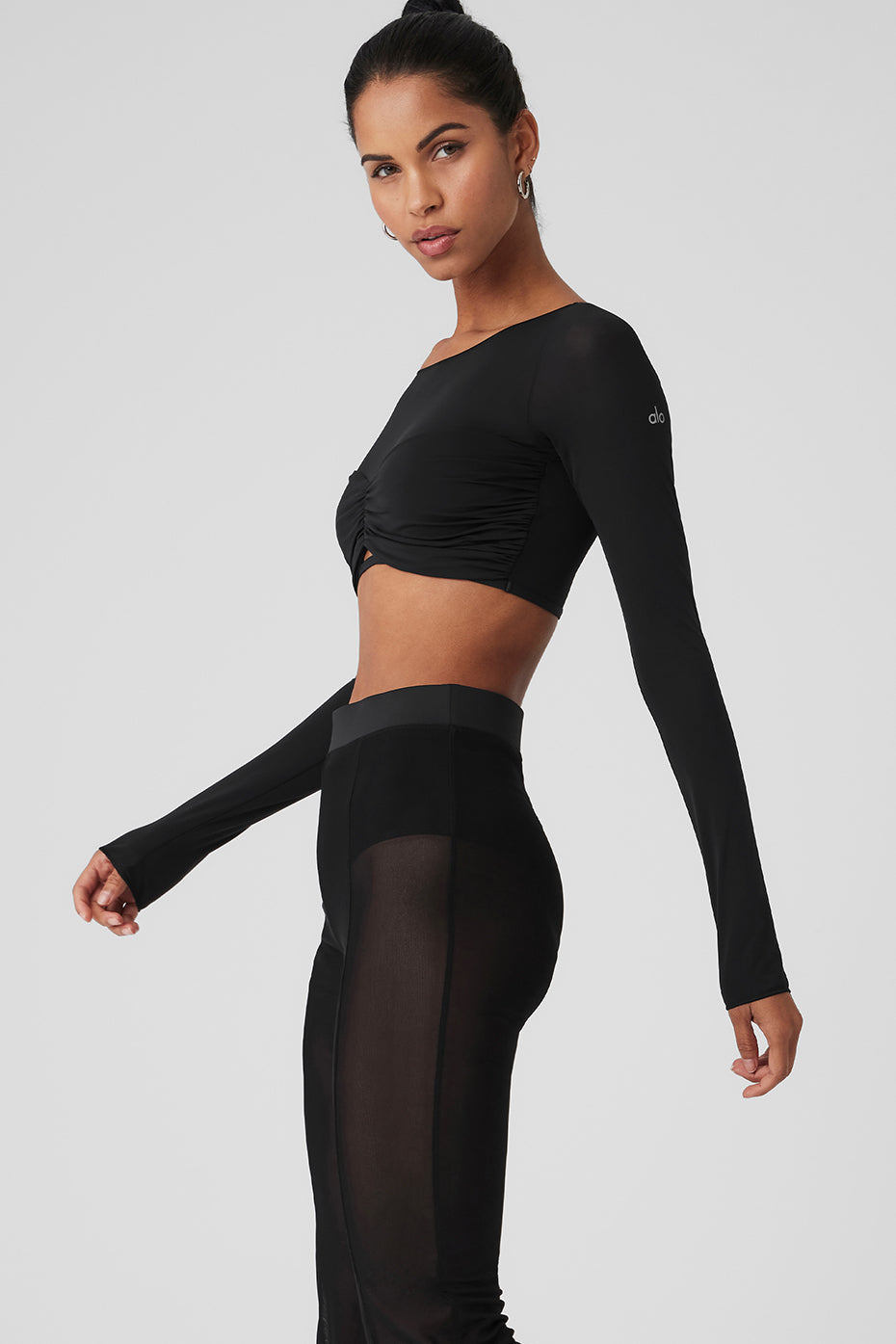 Model showcasing a Mesh Sheer Illusion Cropped Long Sleeve top with boat neck and gathered front.