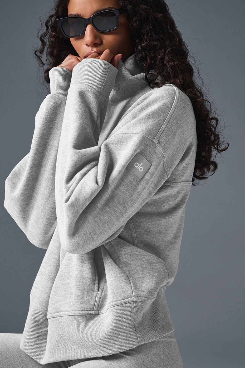 Model wearing a soft gray Hazy Mock Neck Pullover sweater, styled for a cozy oversized fit.