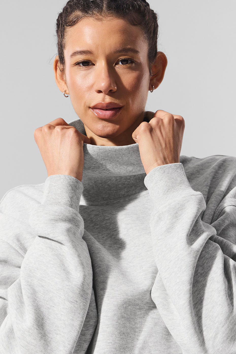 Model wearing Hazy Mock Neck Pullover sweater, showcasing its cozy oversized fit and soft gray fabric.