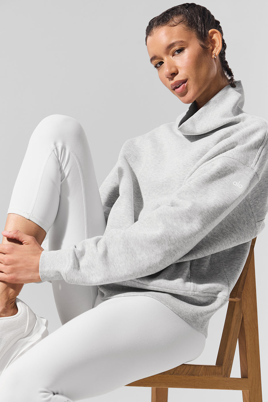 Hazy Mock Neck Pullover in soft grey fabric, oversized fit, styled with white leggings for a cozy, laid-back look.