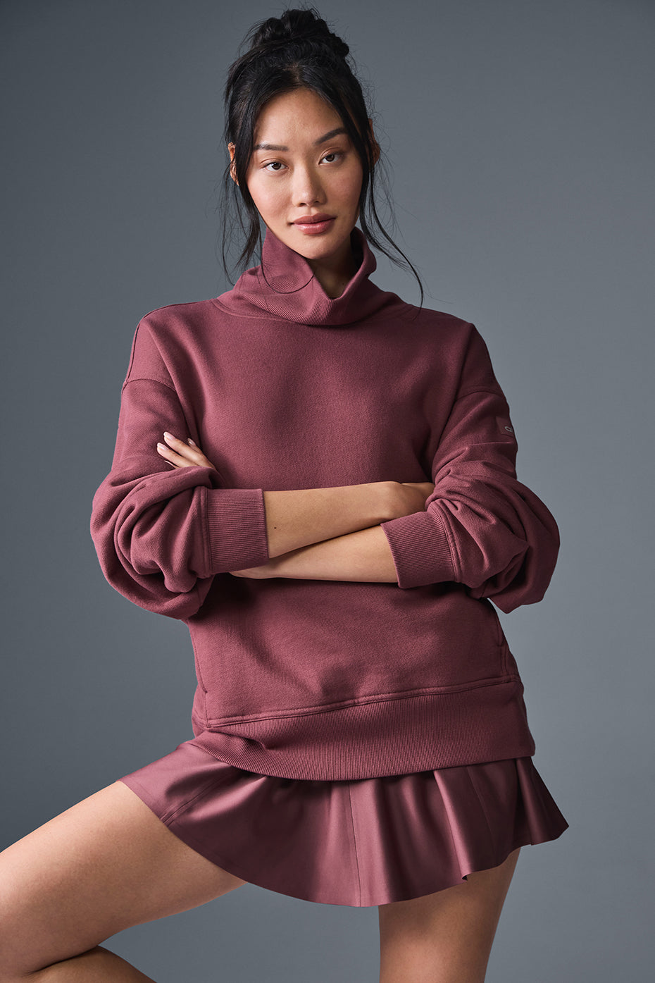 Model wearing Hazy Mock Neck Pullover in burgundy, showcasing its oversized fit and cozy style.