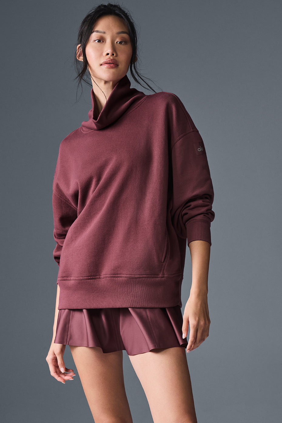 Hazy mock neck pullover in burgundy worn with matching sweat shorts, showcasing a cozy oversized fit.
