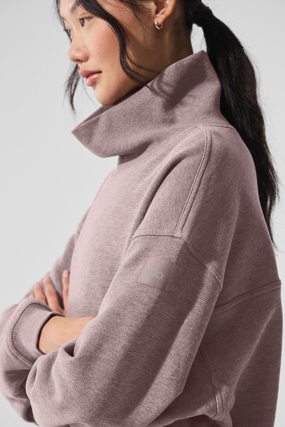 Model wearing a soft oversized Hazy Mock Neck Pullover in pink, showcasing its cozy design and stylish collar.
