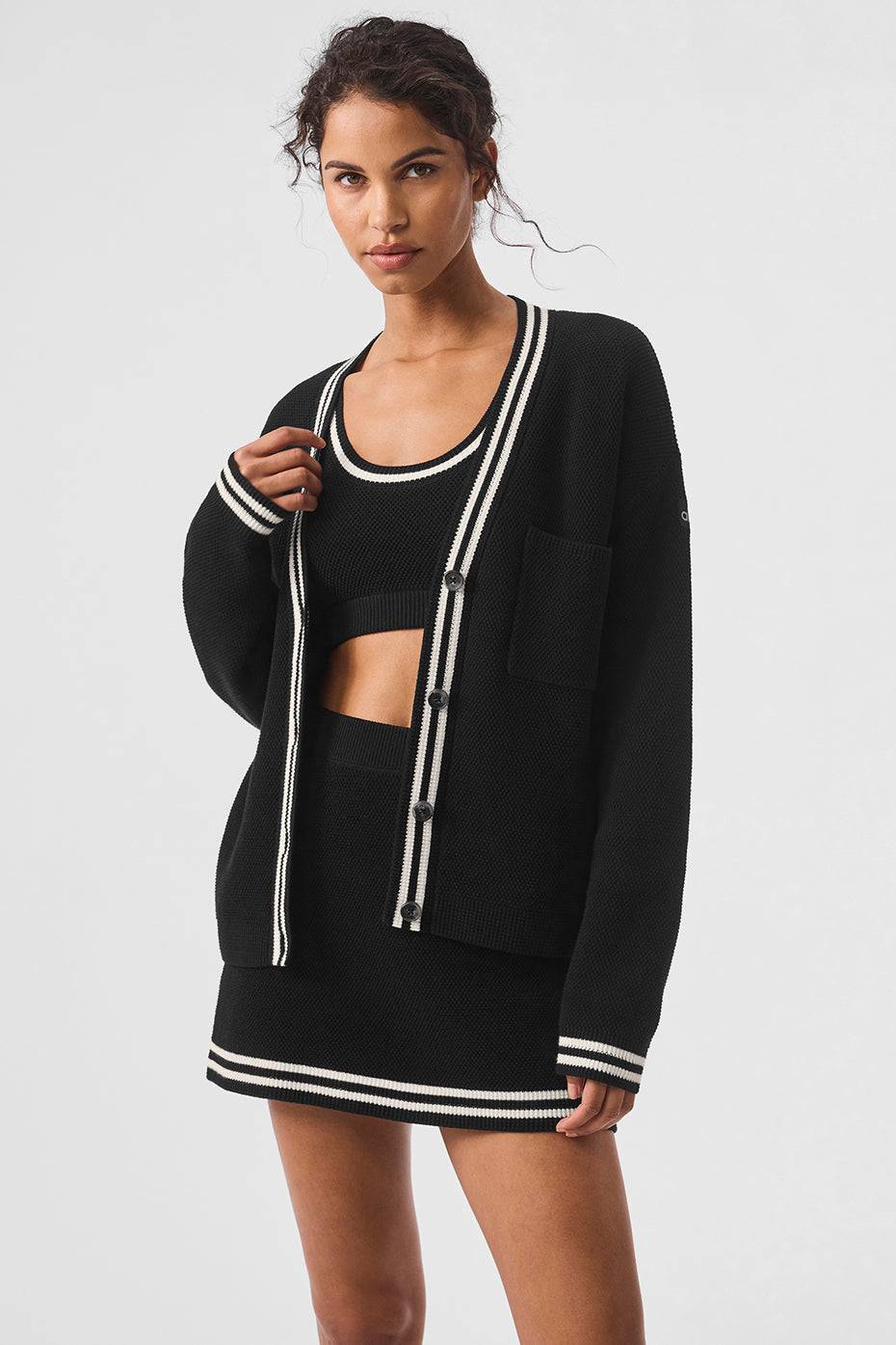 Tennis Club sweater knit cardigan featuring dropped shoulders, ribbed cuffs, and striped trim for a stylish female fit.