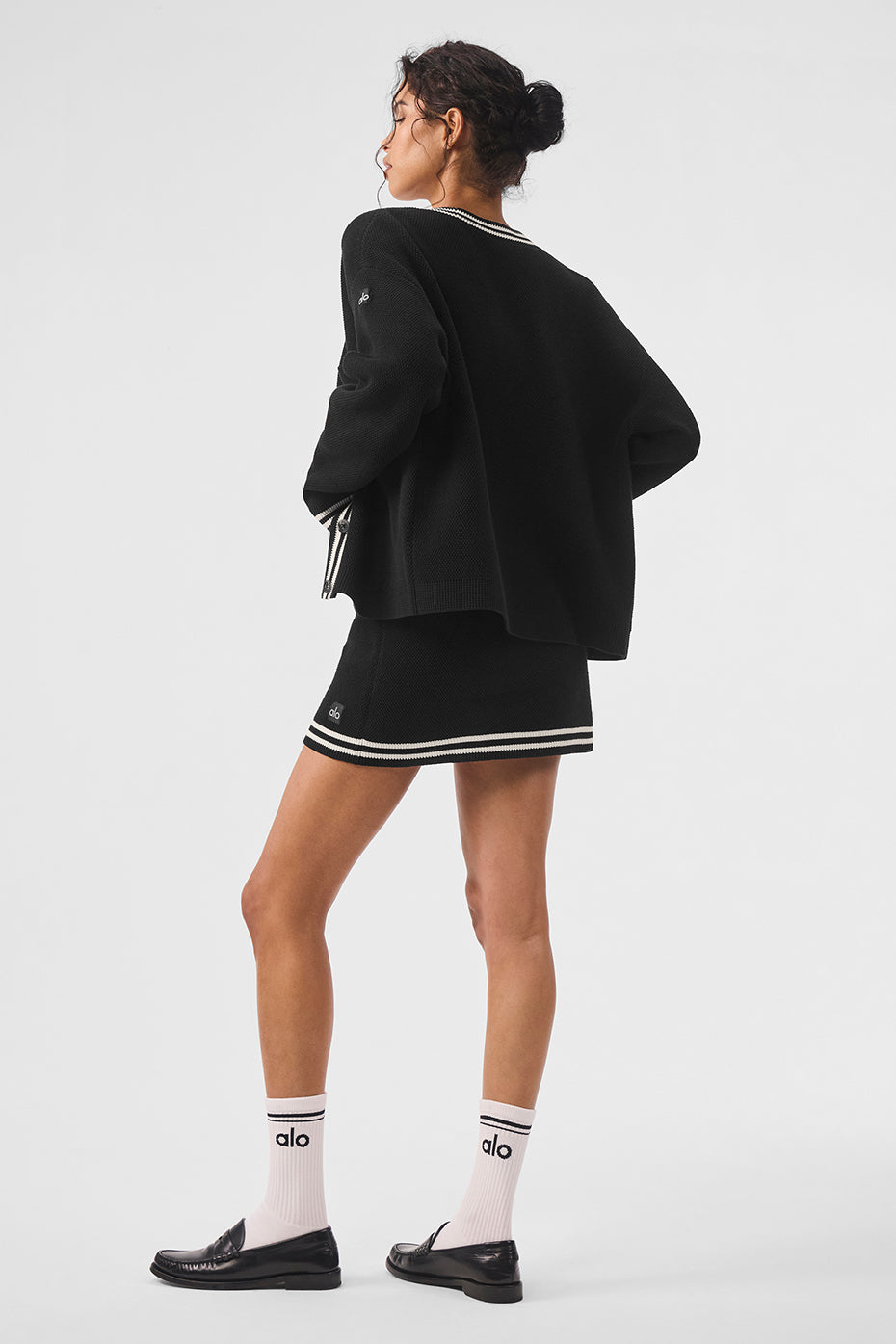 Tennis Club Sweater Knit Cardigan with striped trim, worn with matching skirt and socks, showcasing a stylish sporty look.