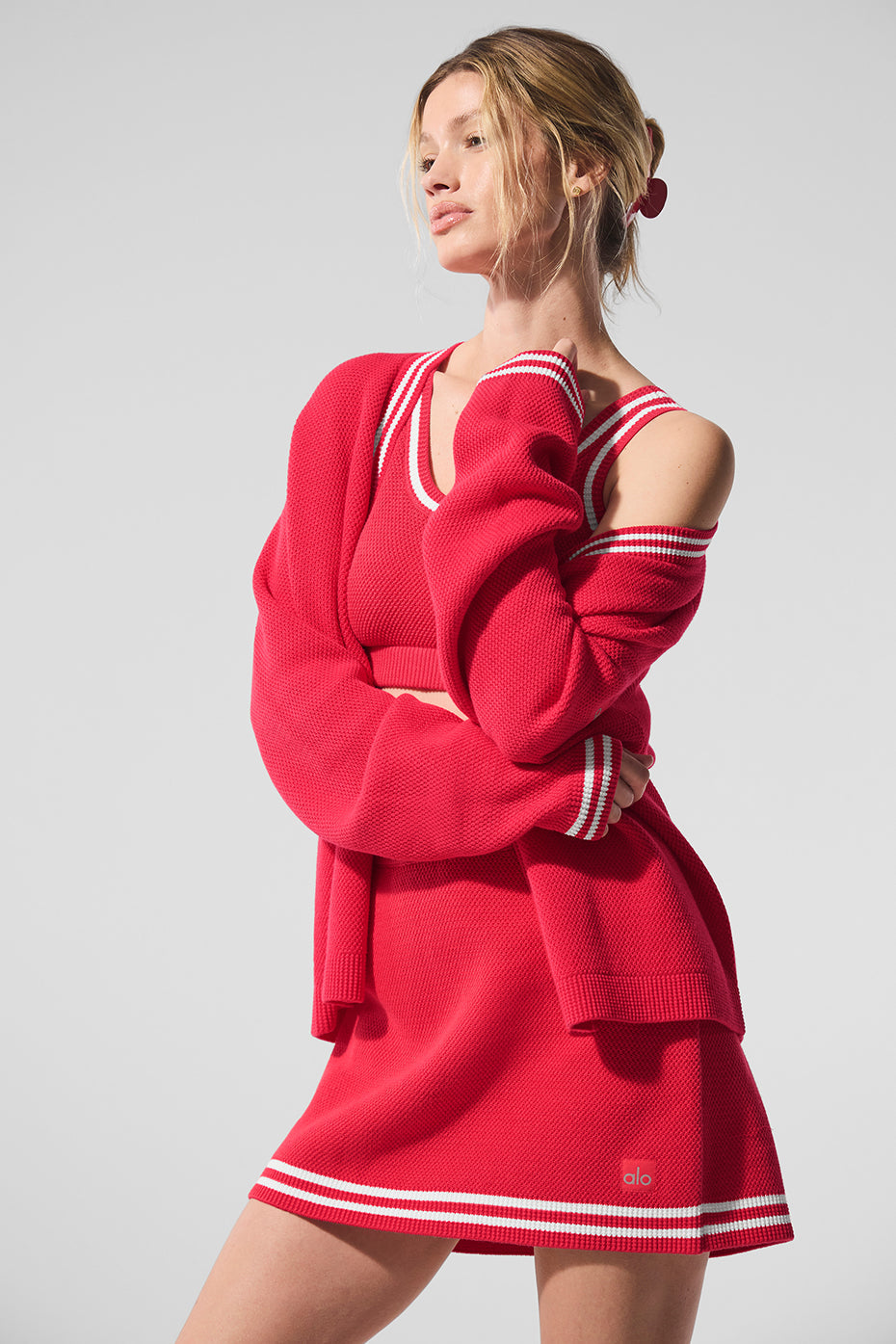 Tennis club sweater knit cardigan in red with striped trim and dropped shoulders, styled with matching skirt.