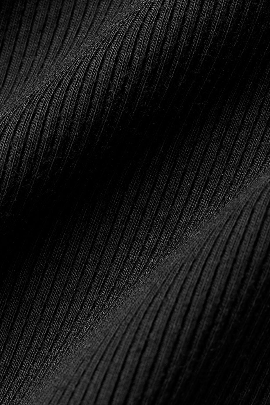 Close-up of ribbed black fabric showcasing the texture of the Ribbed Mesmerize Long Sleeve shirt.