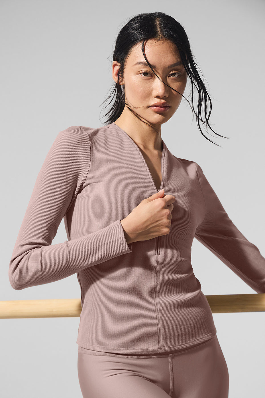 Model wearing Ribbed Mesmerize Long Sleeve with an invisible zipper and close-to-body fit, ideal for layering.