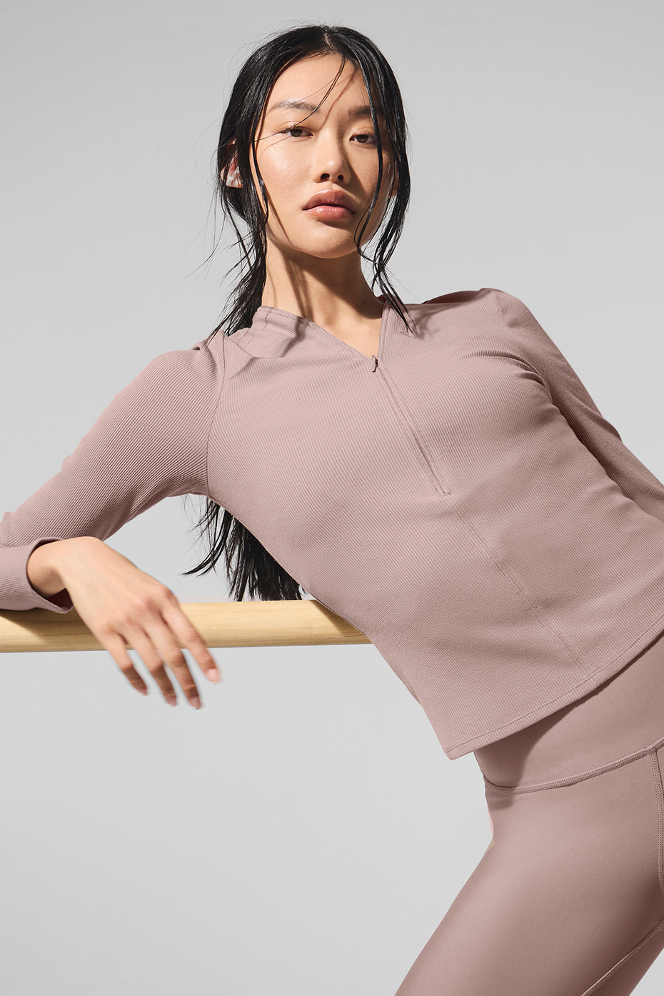 Ribbed Mesmerize Long Sleeve top in mauve, featuring a front zipper and close-to-body fit, perfect for layering.