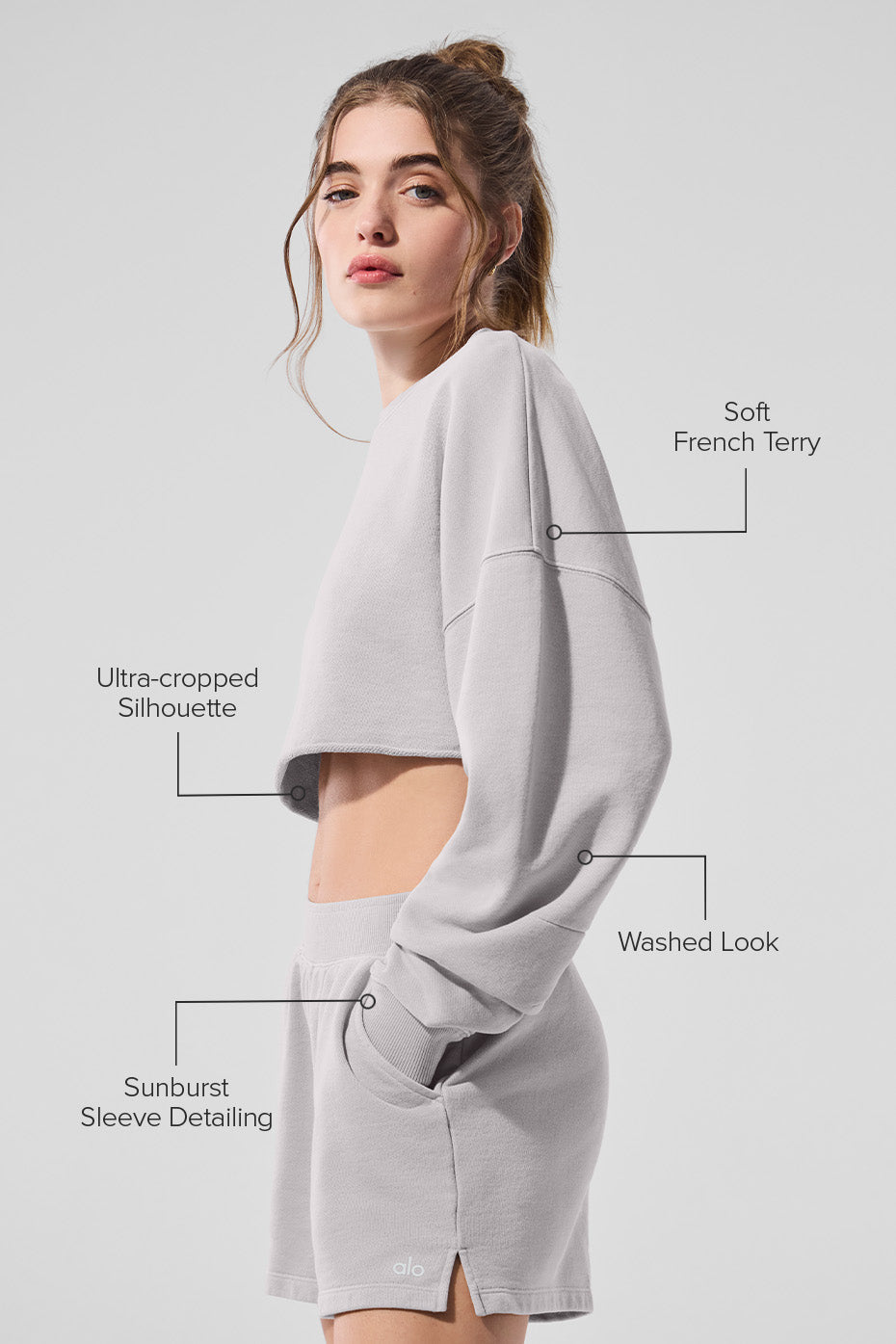 Model showcasing Washed Extreme Cropped Pullover in soft French terry with an ultra-cropped silhouette and sunburst sleeve detailing.