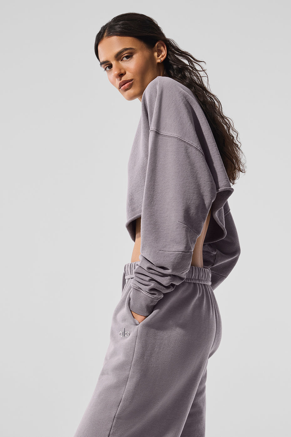 Model wearing washed extreme cropped pullover in gray paired with matching bottoms, showcasing an ultra-cropped silhouette.
