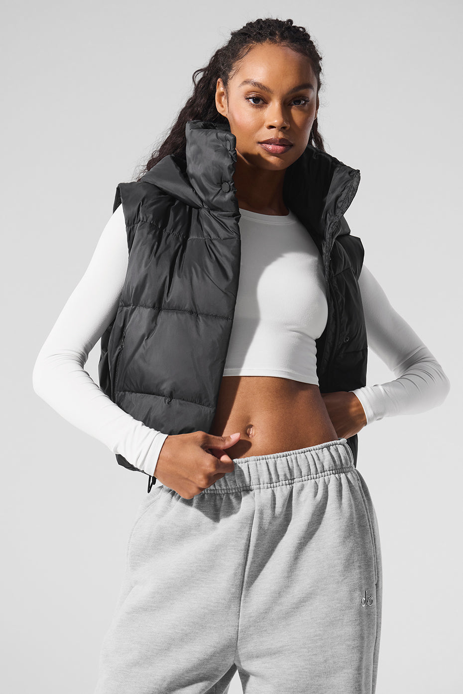 Model wearing a Gold Rush Puffer Vest, showcasing its cozy-luxe, weather-ready design with cinched waist and hood.