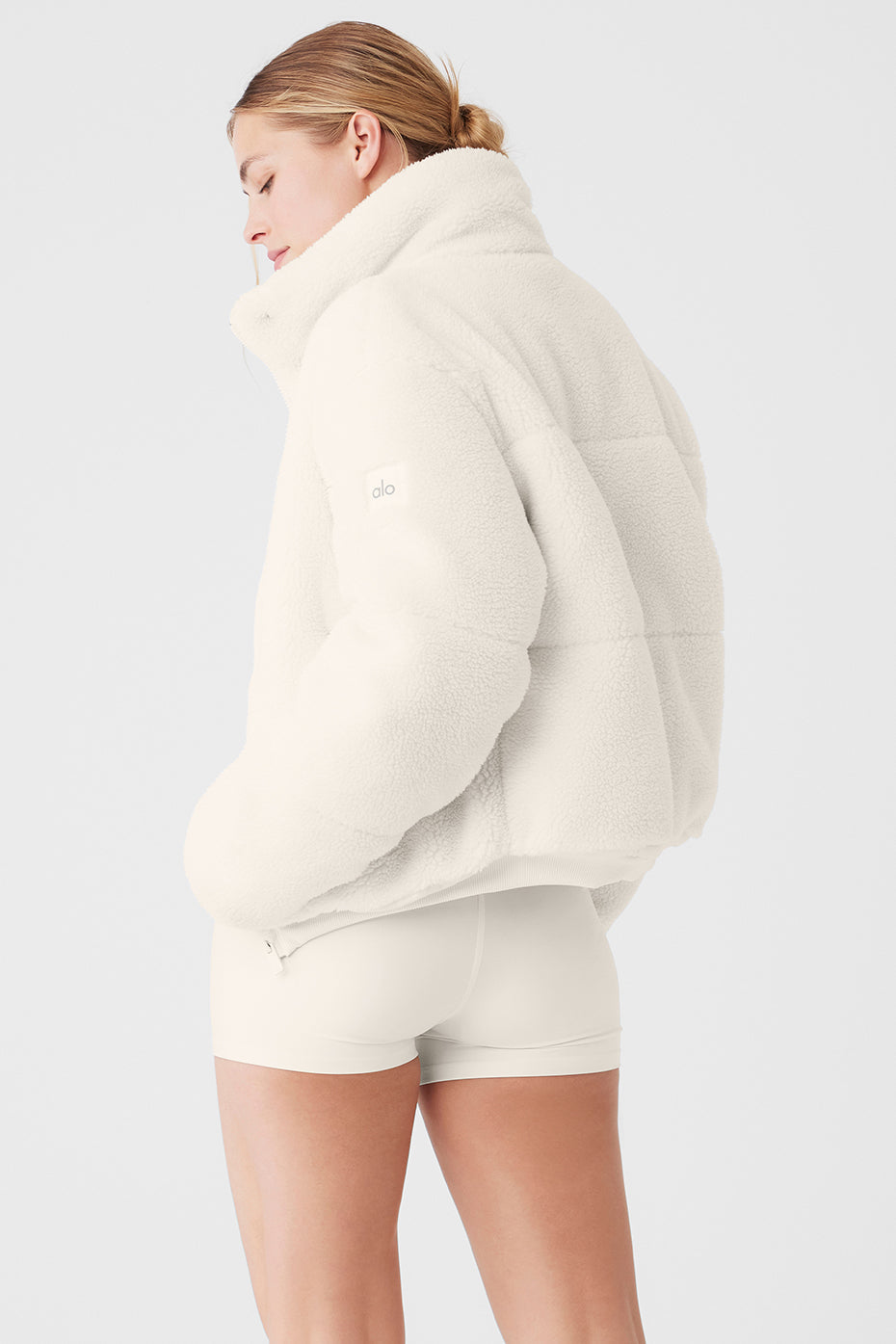 Back view of Sherpa Snow Angel Puffer in white, featuring a tall collar and cozy fit, perfect for winter outings.