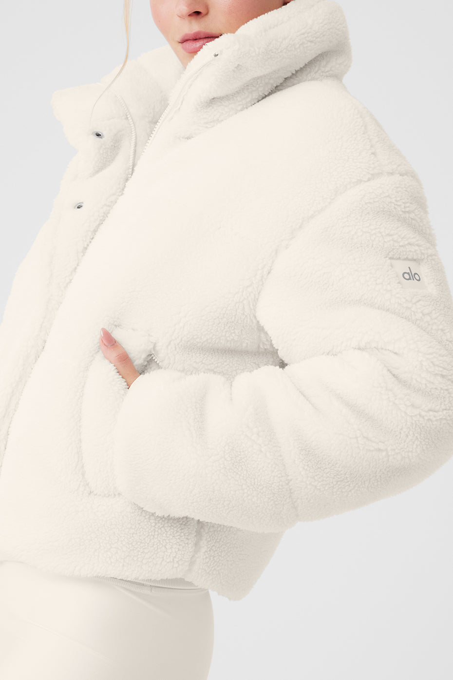 Sherpa Snow Angel Puffer in white, featuring plush fabric, tall collar, and zippered pockets for warmth and comfort