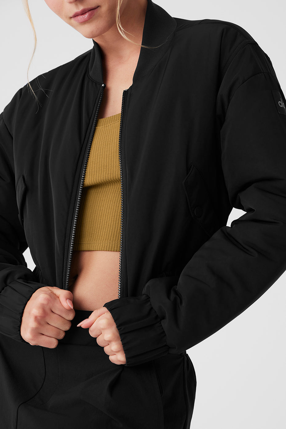 Cropped Break Line Bomber Jacket in black with ribbed collar and two front snap pockets, perfect for stylish outings.