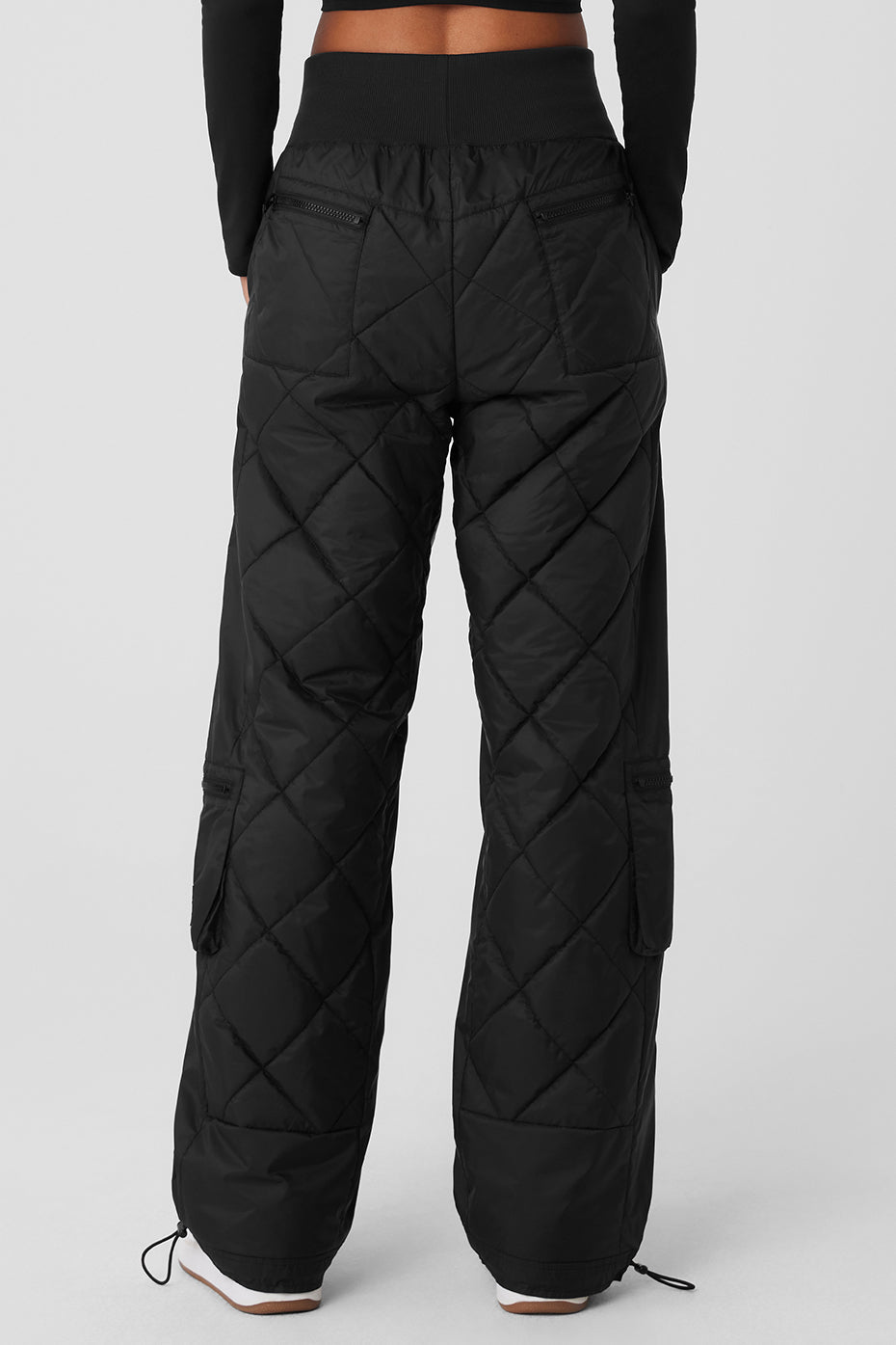 Back view of high-waist Snowrider puffer pant featuring quilted finish and wide ribbed waistband.