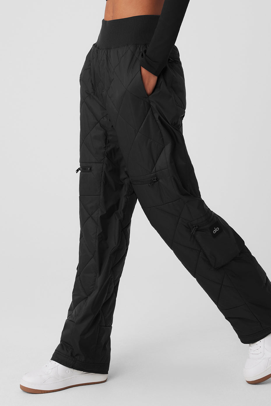 High-waist Snowrider puffer pant in black with quilted finish, wide waistband, multiple pockets, and bungee hems.