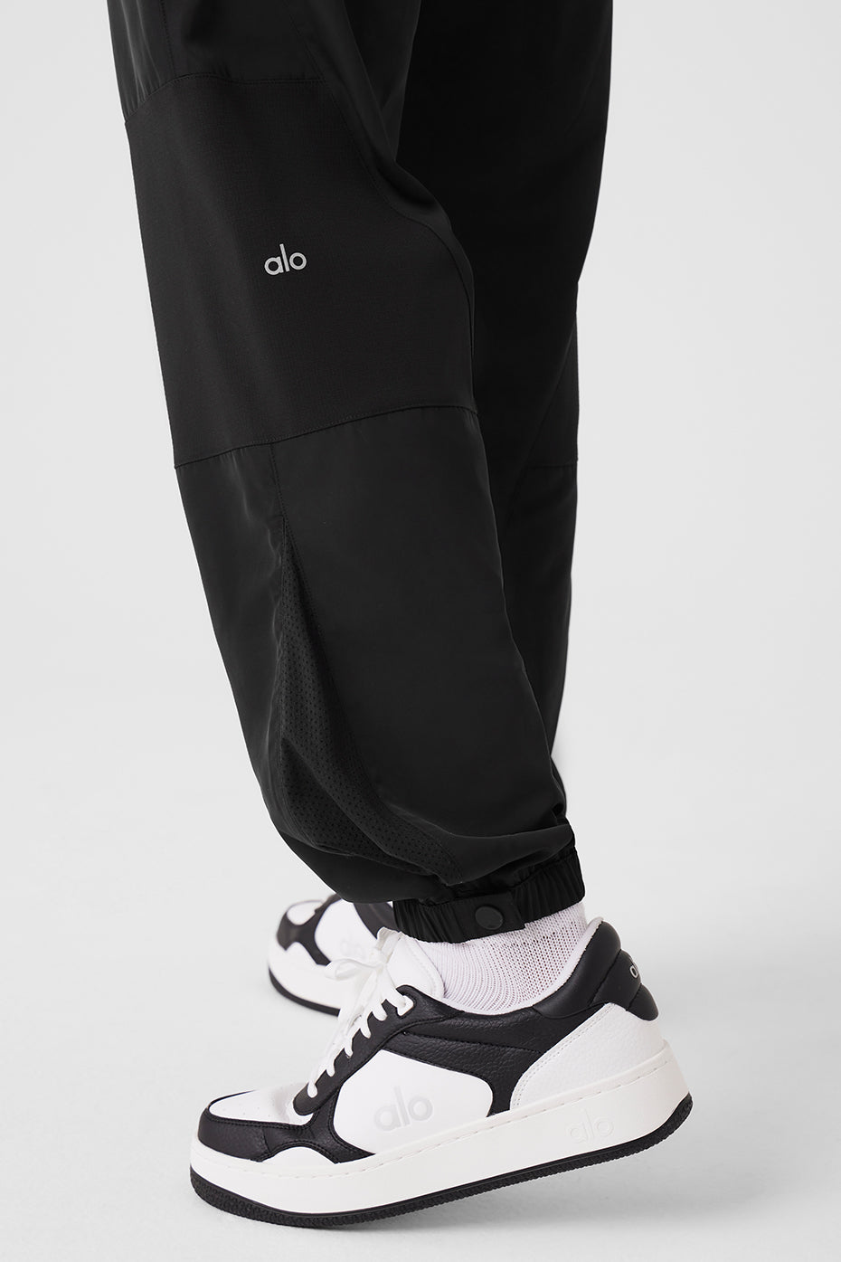 Close-up of Mixed Media Reinvention Jogger featuring stretchy cuffs and sporty design paired with stylish sneakers.
