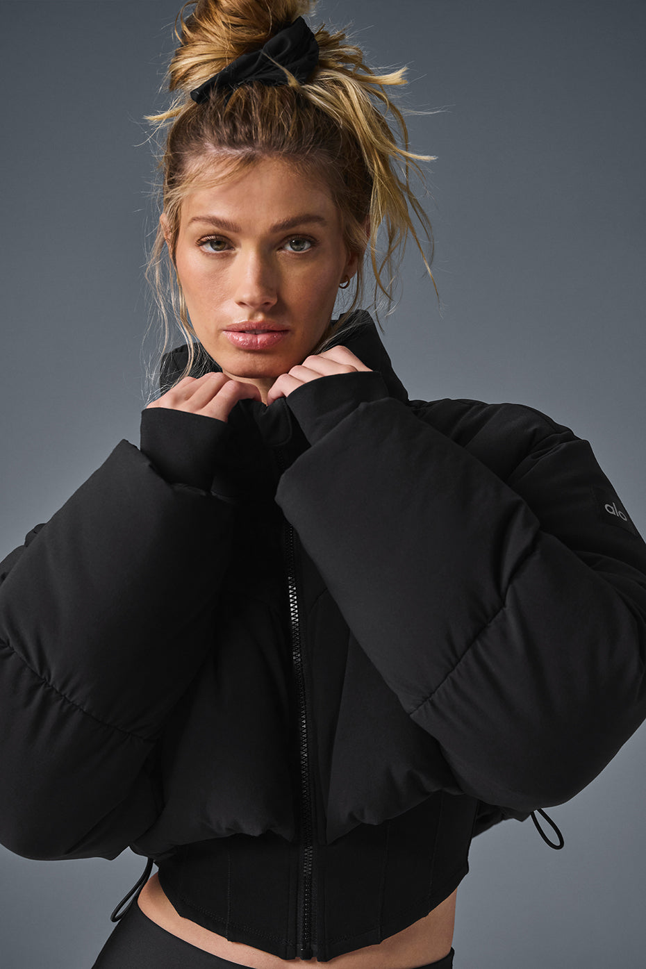 Main Act Corset Puffer cropped coat in black with waist-snatching corset hemline for warmth and style