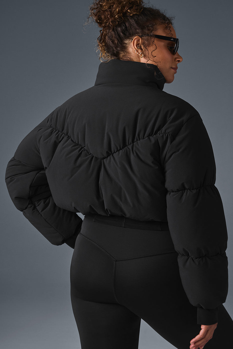 Main Act Corset Puffer jacket in black with cropped silhouette and chic design, providing warmth for chilly days.