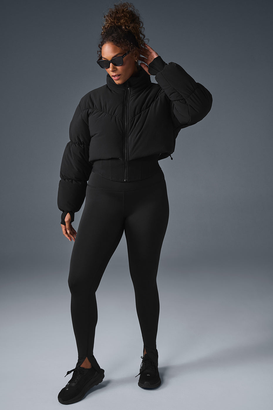 Main Act Corset Puffer jacket featuring cropped silhouette and warm lightweight design with stylish leggings.