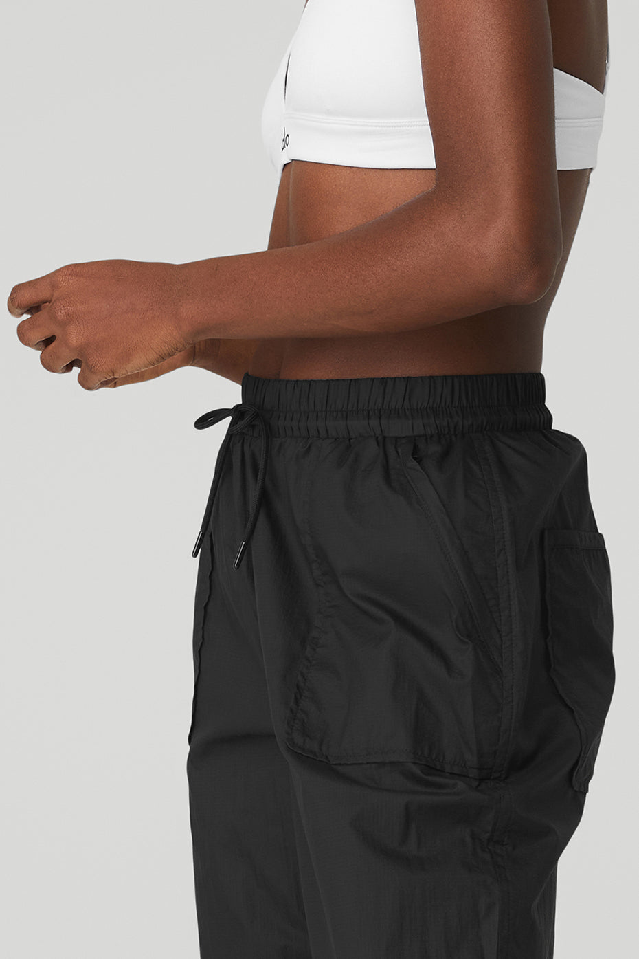 Side view of a model wearing Cloud Nine Pant featuring high waist, drawcord and zippered pockets.