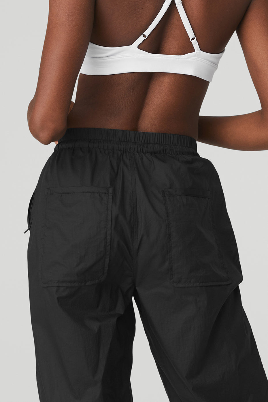 Back view of a model wearing Cloud Nine Pant featuring zippered pockets and a high-waist design.